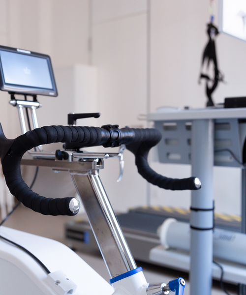Ergometer mit Monitor in einem hellen Trainings- oder Therapieraum.